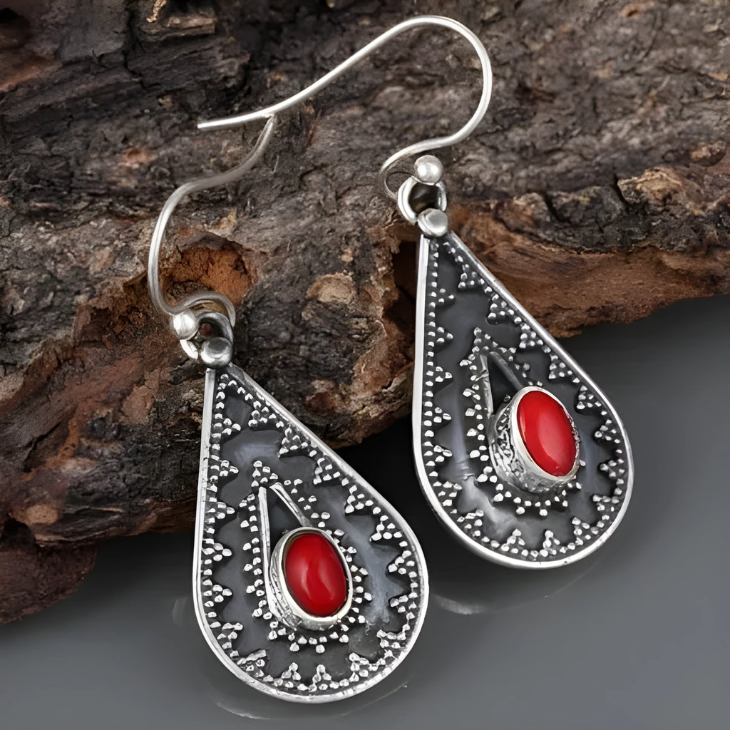 Silver drop-shaped retro earrings for women with European and American national style design.