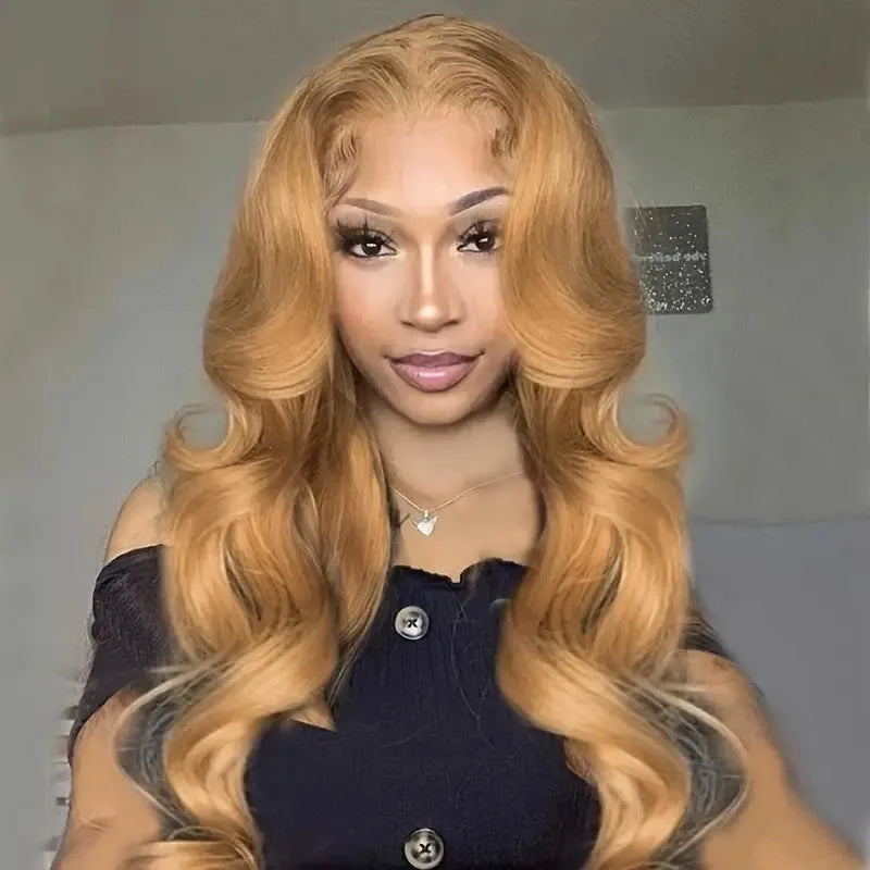 Long golden light brown synthetic wig with big curly waves and side bangs laid flat.