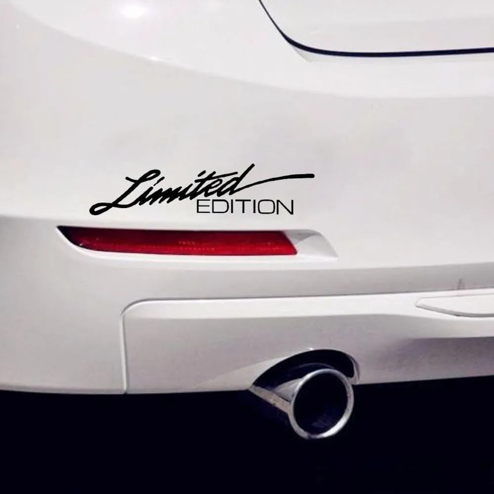 A black, white, and colourful British style reflective plastic bumper sticker, shown at its 16cm by 3.8cm size.