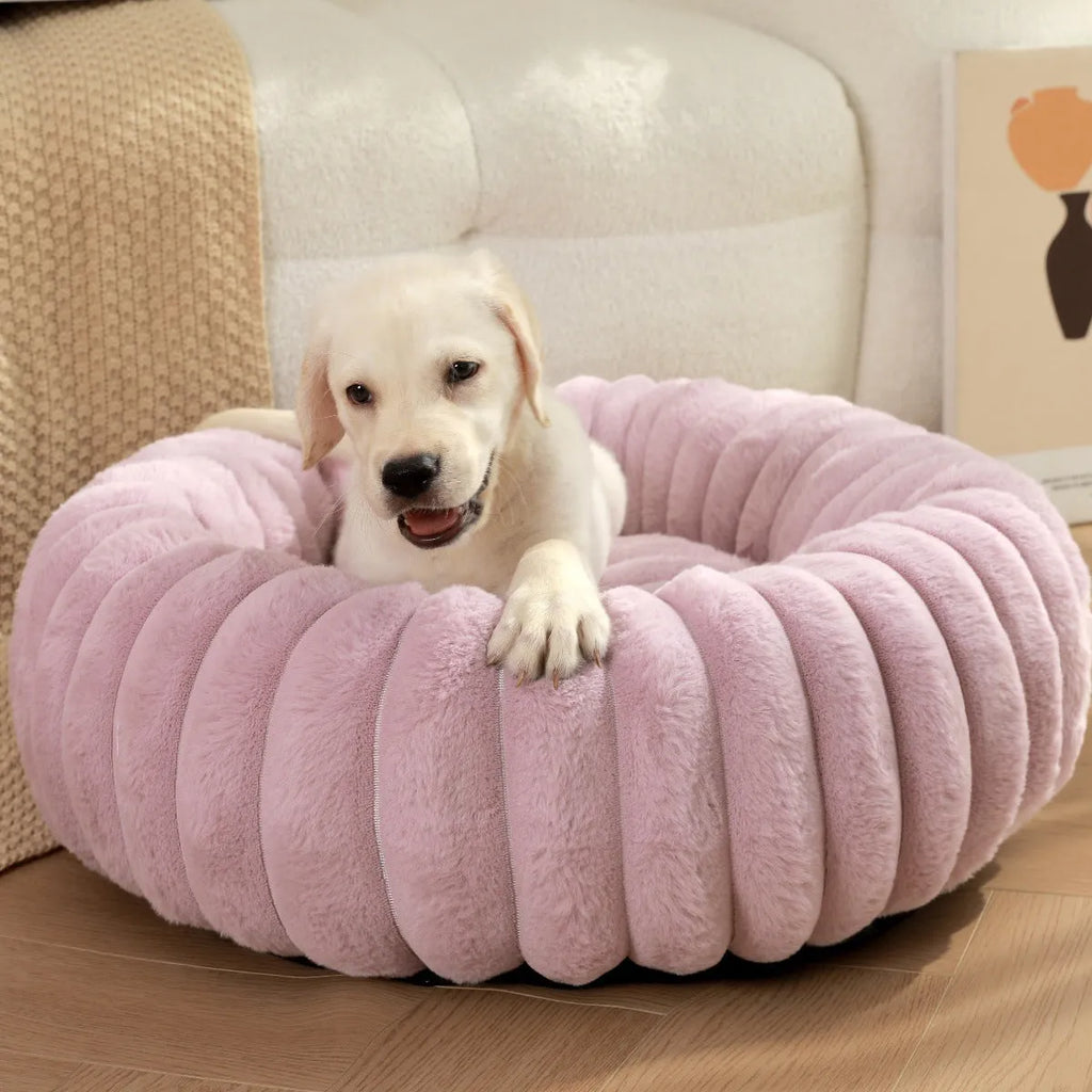 Round plush pet bed in beige with raised rim, size L 60cm, on a wooden floor