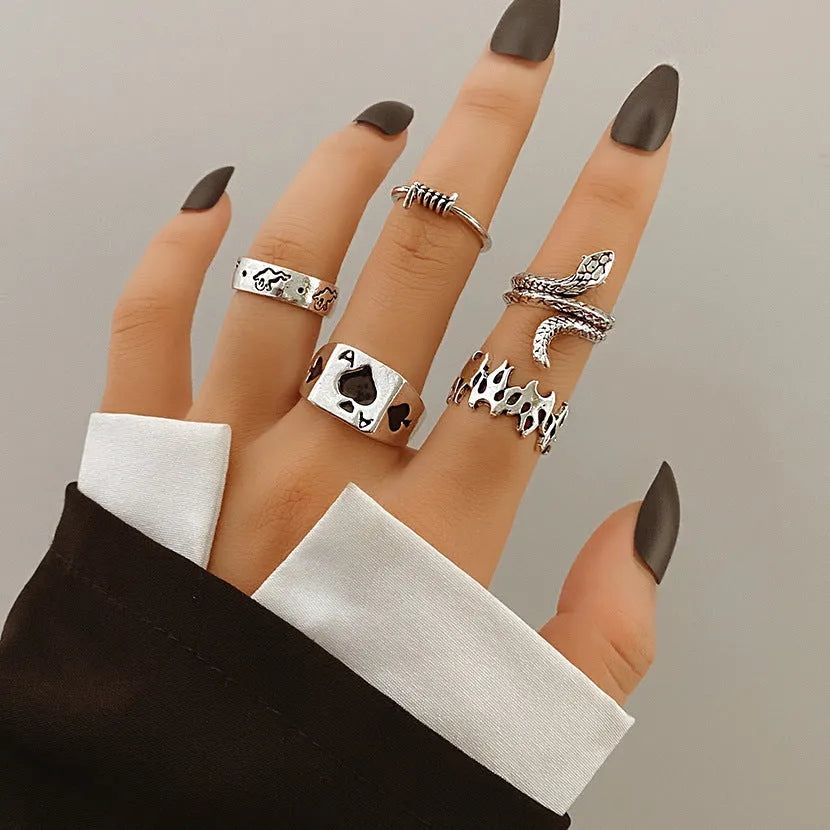Alloy ring set with butterfly and snake retro geometric designs on display
