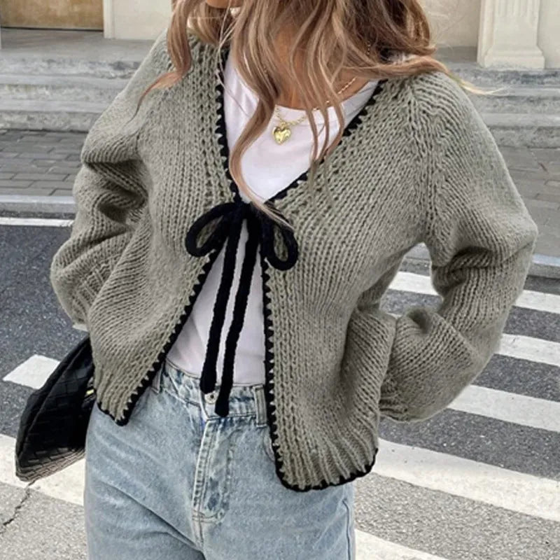 Lace-up cardigan sweater with crocheted flower detailing in solid colour