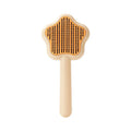 Green self-cleaning cat grooming comb with stainless steel needles and wand handle