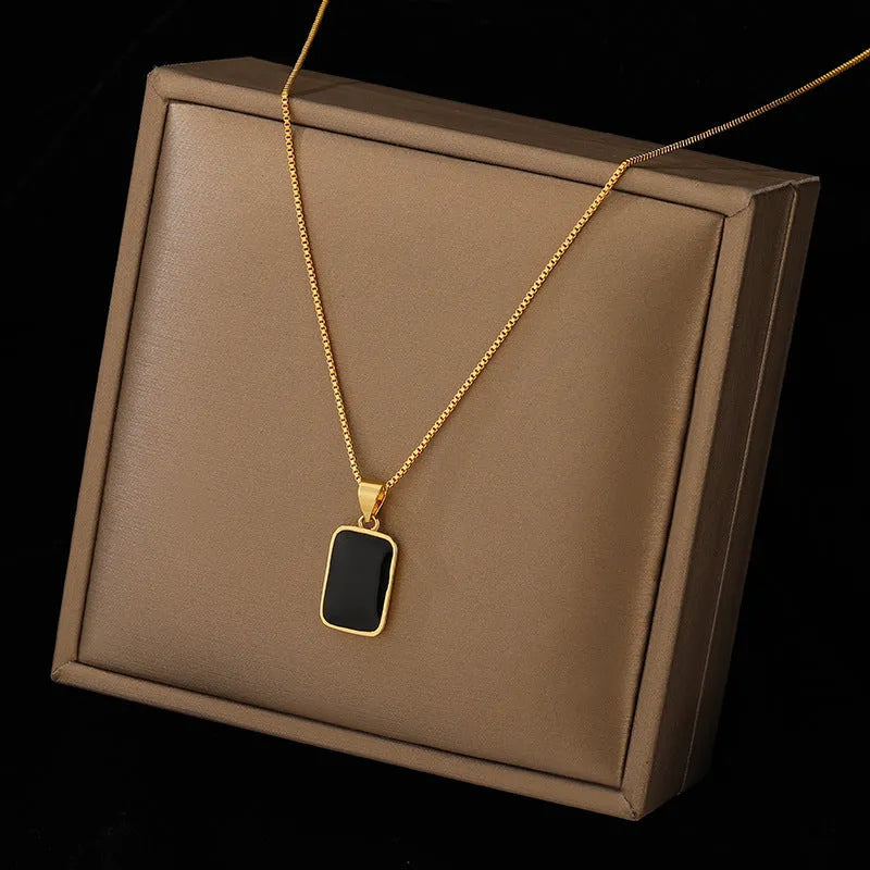 Rectangular pendant necklace in 18K gold plated titanium steel with box chain, black geometric design, 41-50cm.
