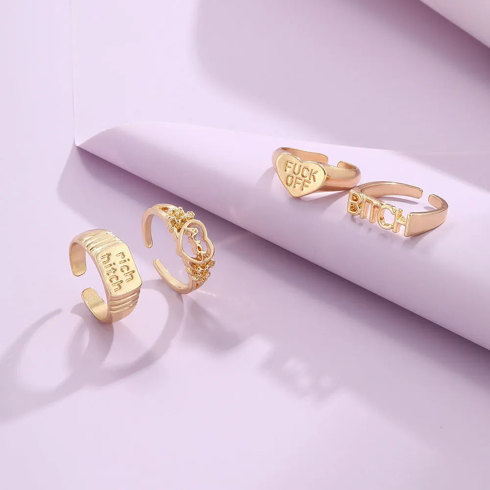 Vintage alloy ring set of four with heart shapes and letter cutouts, electroplated finish, colour JH1084