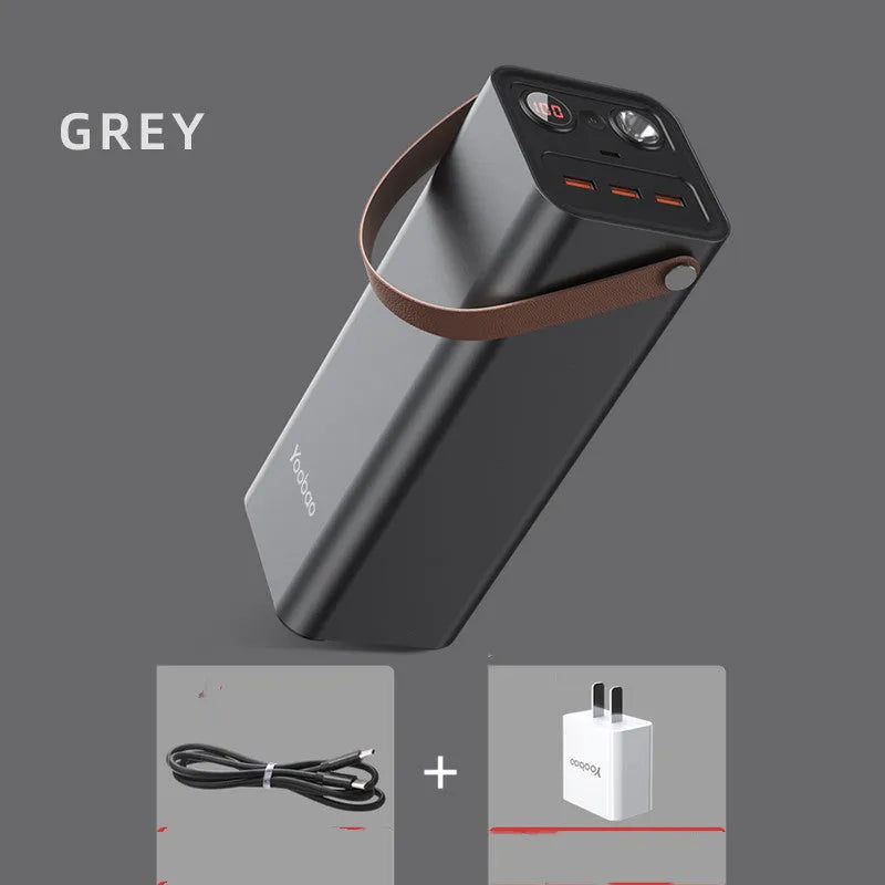 Black portable power bank with 220V AC outlet, USB ports, and solar charging panel.