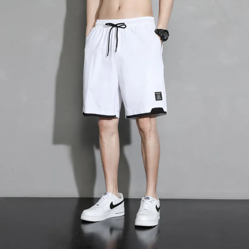 Boys' loose-fitting cotton summer shorts in black, shown on a hanger.