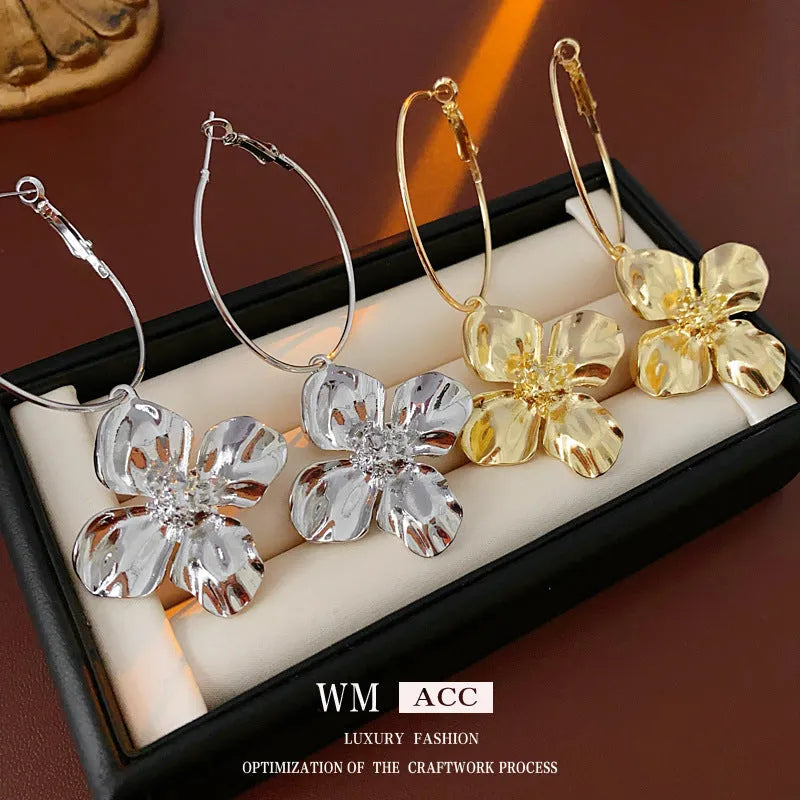 Gold and silver metal earrings with floral geometric design and electroplated finish