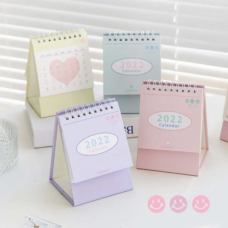 Cream coil-bound desk calendar for 2022, paper, 210g, Regular size 100x100x172mm, on a desk