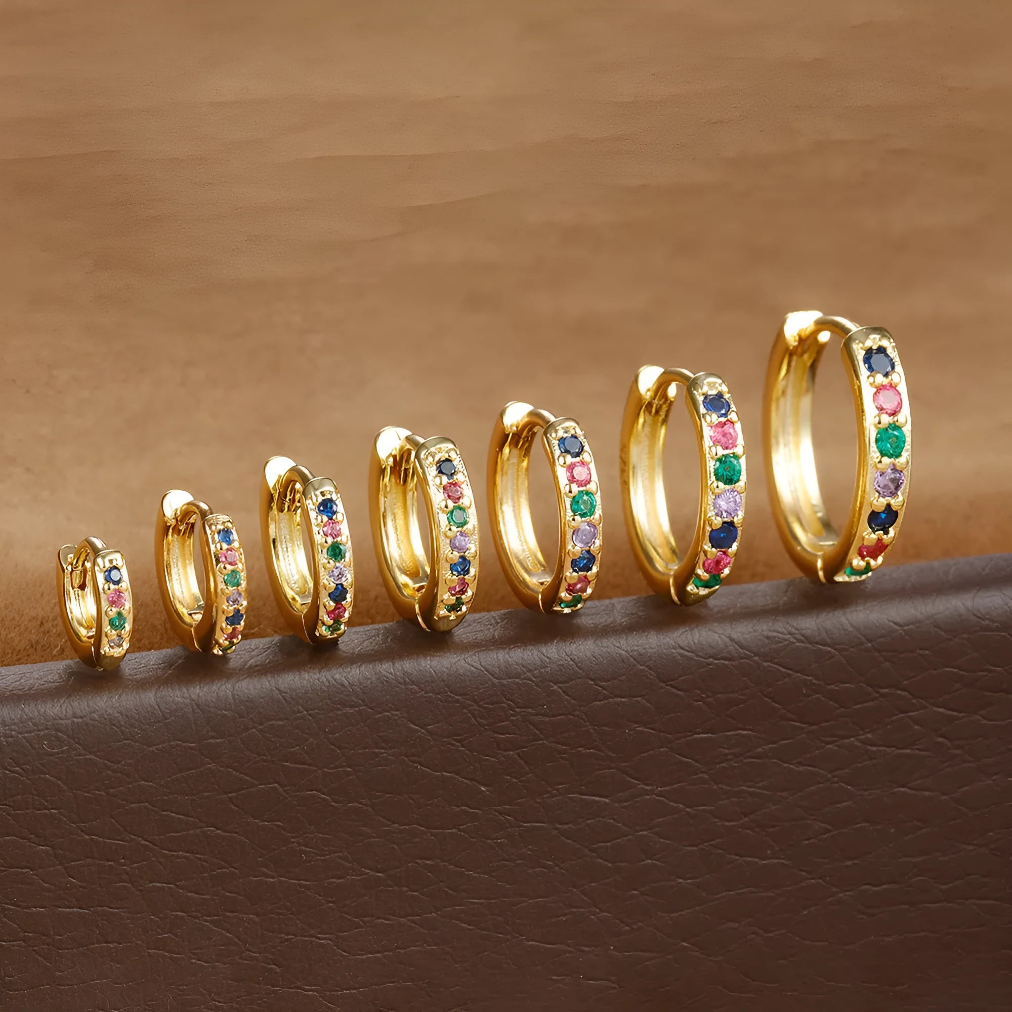 Circle zircon perforated stud earrings in gold, rose gold, and silver colours showing different size options