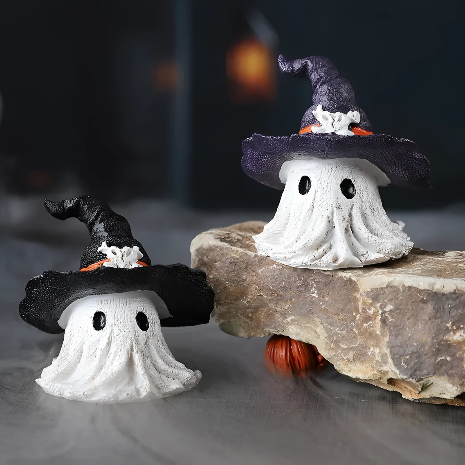 A purple and a black solid resin wizard hat ornament for holiday decoration.