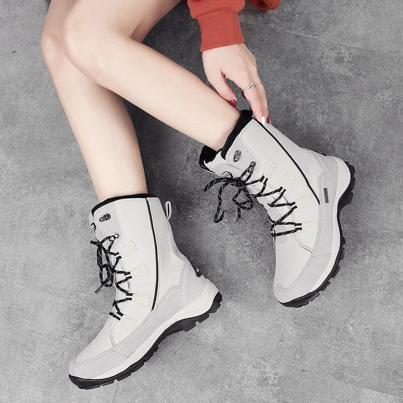 Women's black mid-calf thermal snow boots with a round toe and genuine leather upper on a rubber sole.