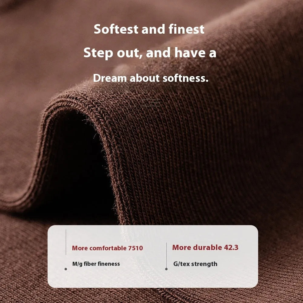 Five pairs of men's solid colour mid-calf socks made from combed cotton, shown in assorted colours.