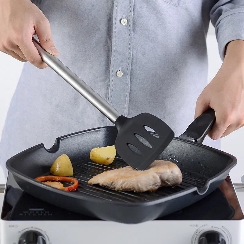 Black silicone kitchen utensil set with stainless steel handles showing four different utensil types