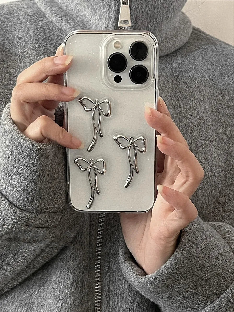 Metal bow iPhone case with anti-drop function and 3D epoxy drip glue detail, available for iPhone 15, 14, 13, 12, and 11 models.