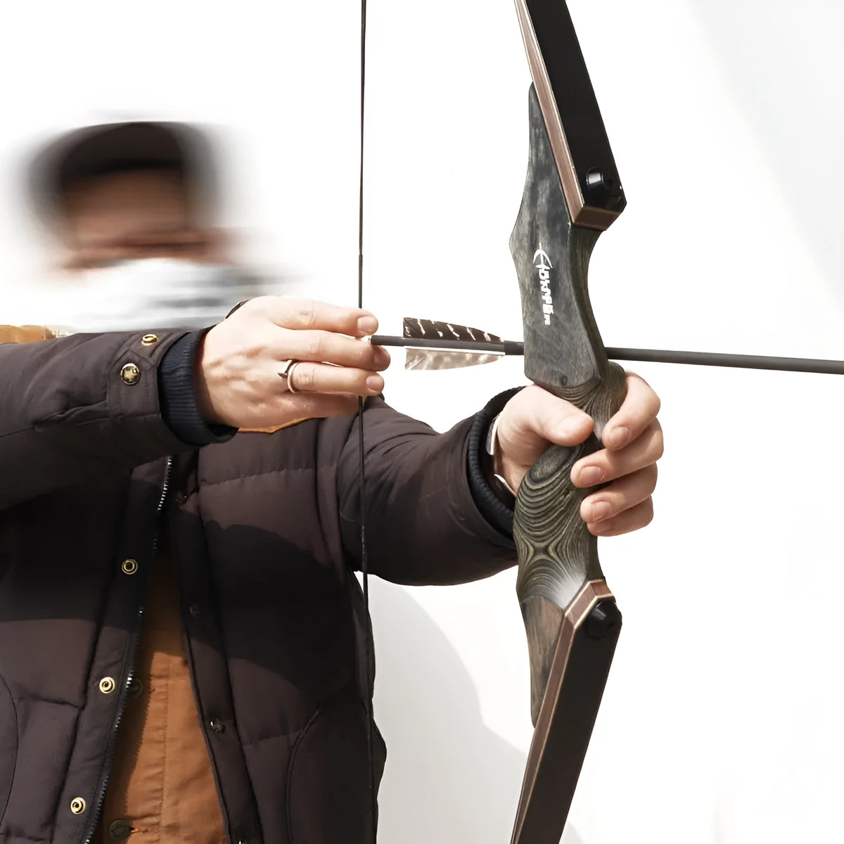Traditional wooden recurve bow with colourful technology wood handle and multi-laminate limbs on display