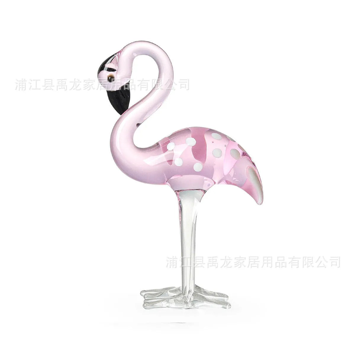 Pink and white crystal flamingo decorative ornament on a table.