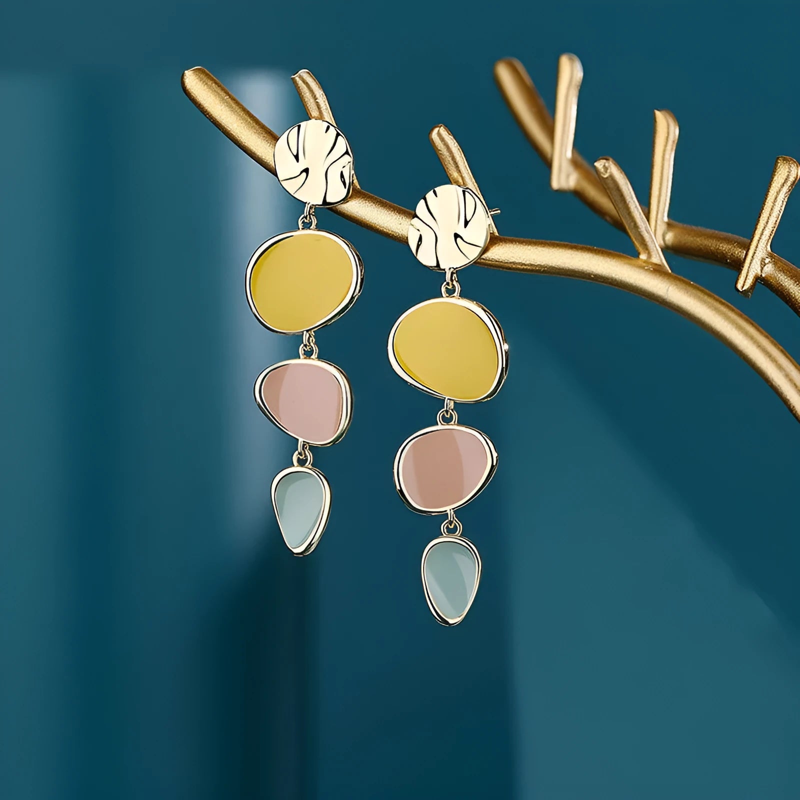 Sterling silver alloy Morandi three-colour oil drip simple wafer disc earrings on a white background.