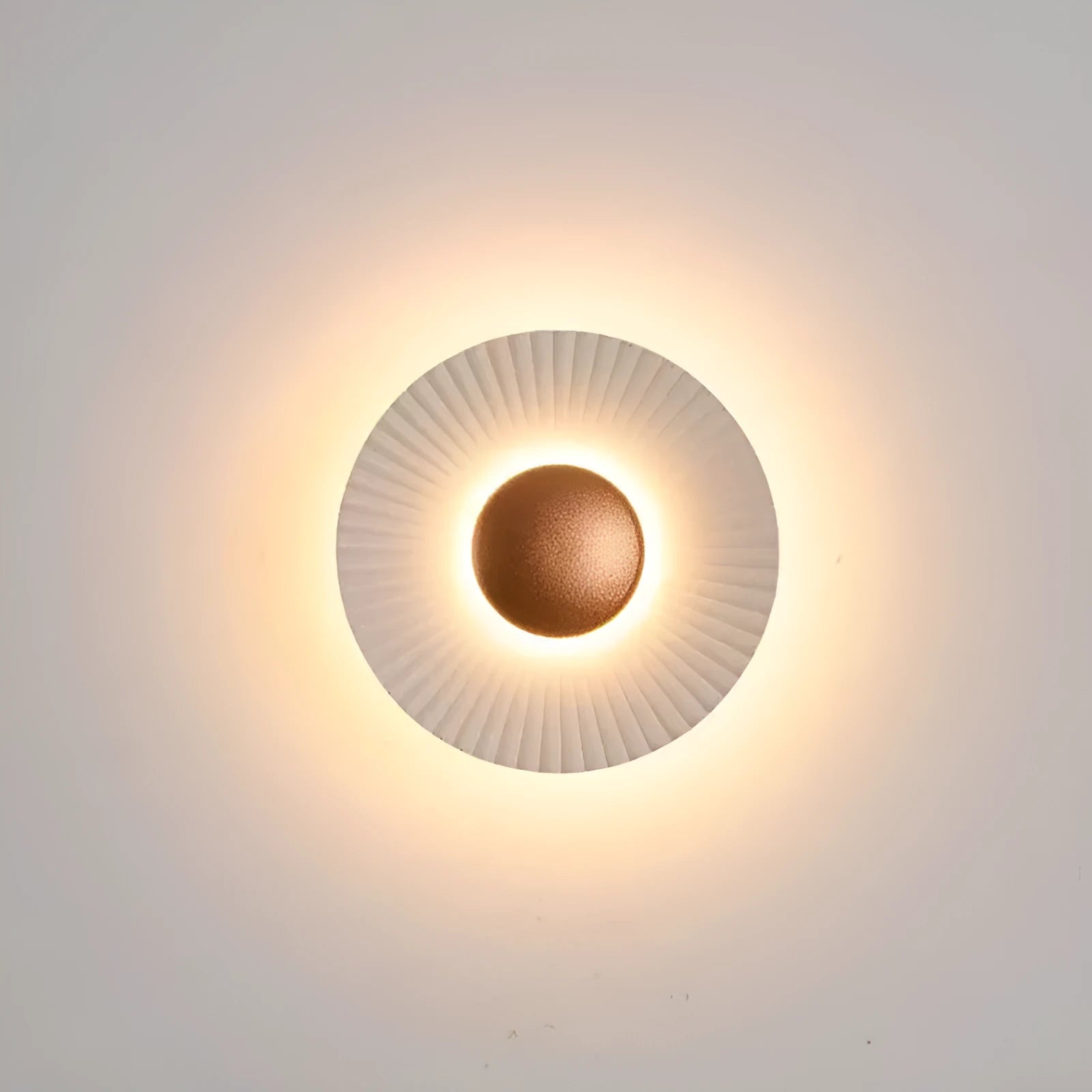 Round aluminium wall lamp with LED light in a white and gold colour option.
