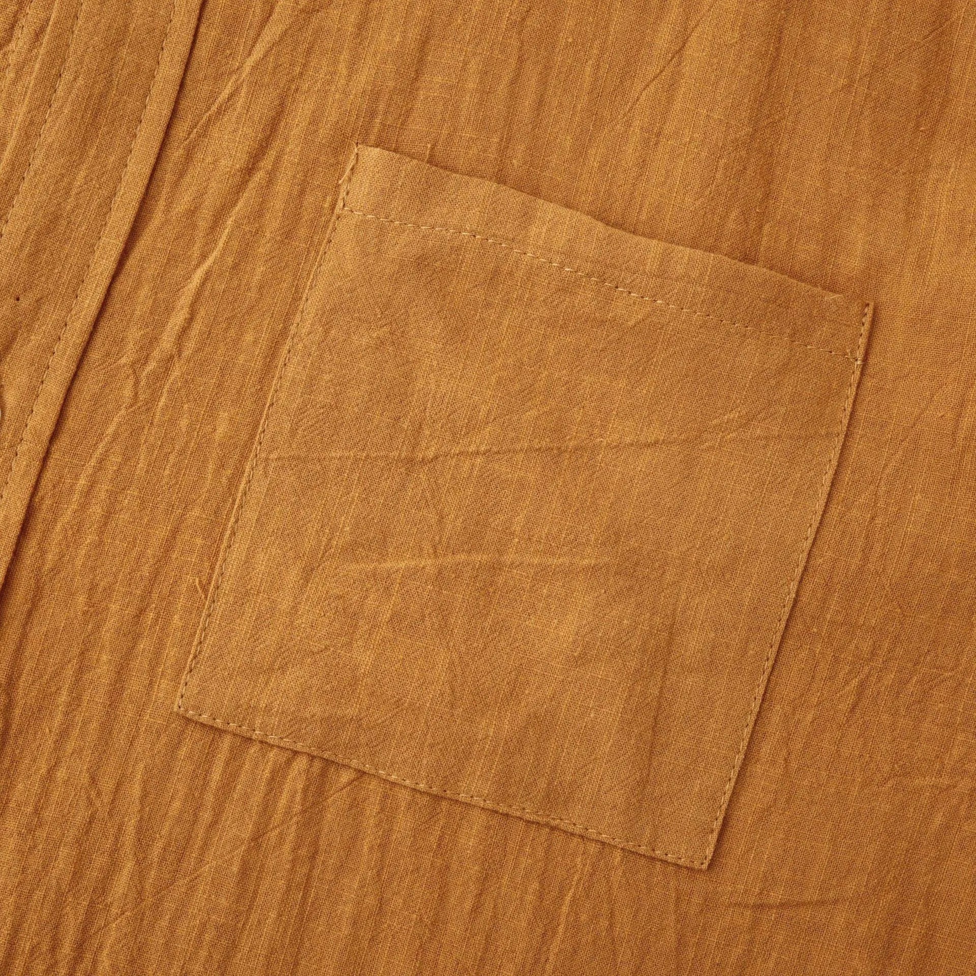 Brown men's slim fit long sleeve shirt and casual trousers on a hanger.