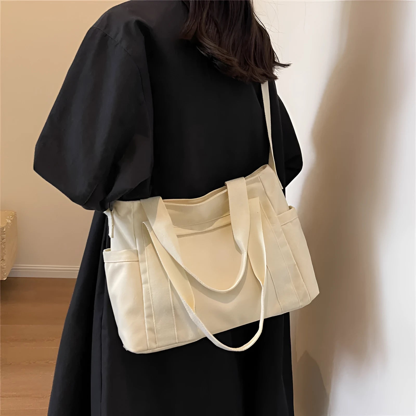 Large solid colour polyester canvas shoulder bag for women showing external pocket and strap.