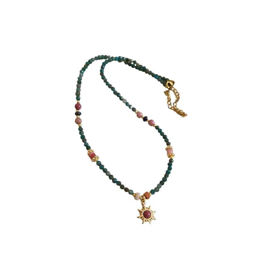 Freshwater pearl necklace with blue sun stone pendant on an adjustable clavicle chain.