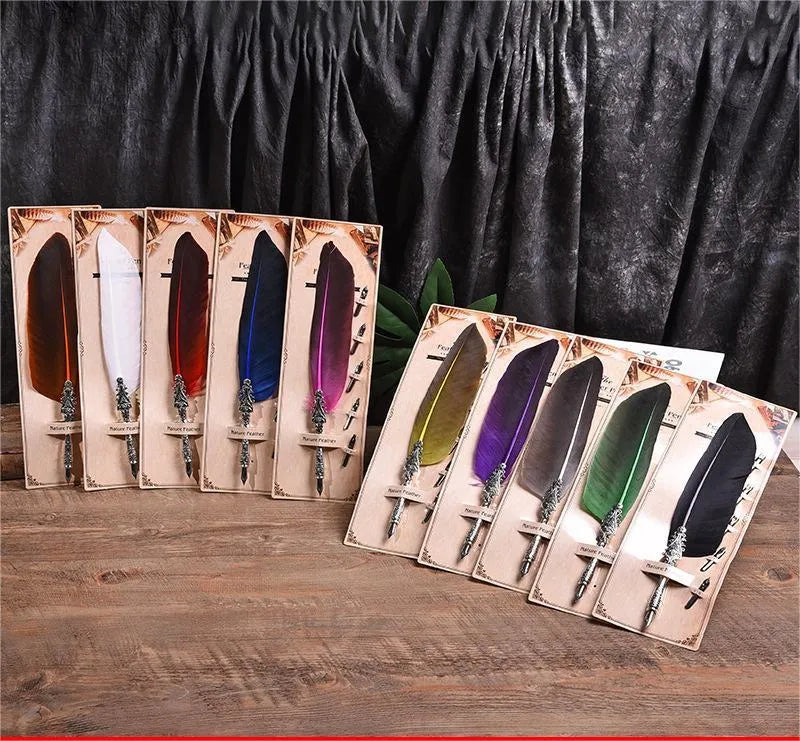 Vintage feather dip pen with zinc alloy holder in assorted colours on a wooden desk