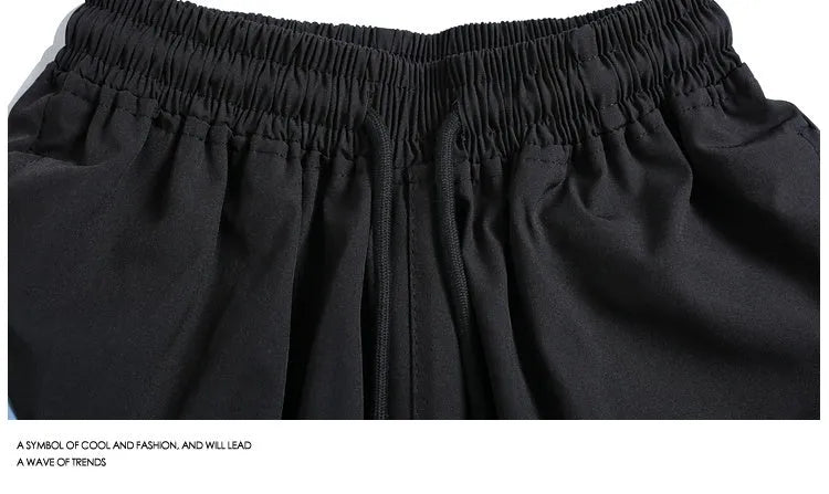 Men's black quick-drying sports shorts with elastic waistband and loose fit