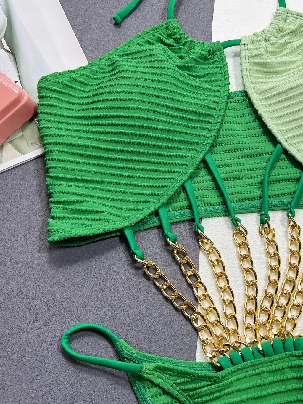 Green women's one-piece swimsuit with a hollow cutout design on the front.