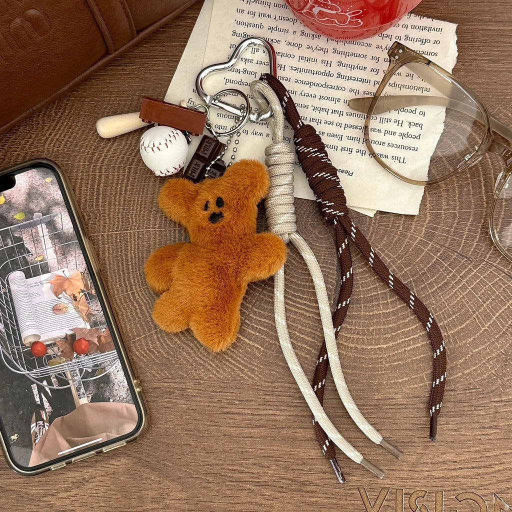 Brown plush bear pendant keychain attached to a bag, soft toy decoration