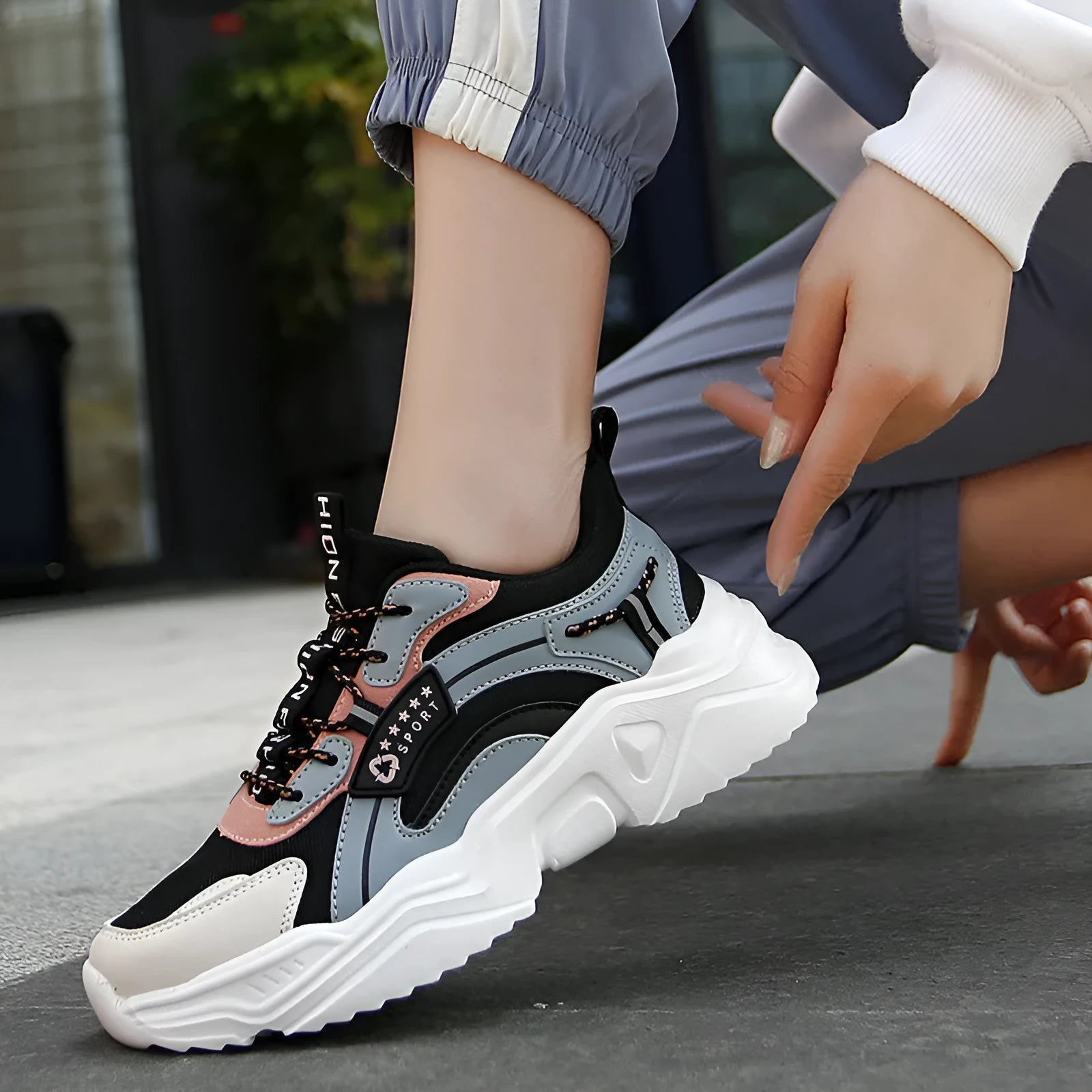 Women's white casual sports shoes with mesh upper, thick PU sole, and a buckle fastening.