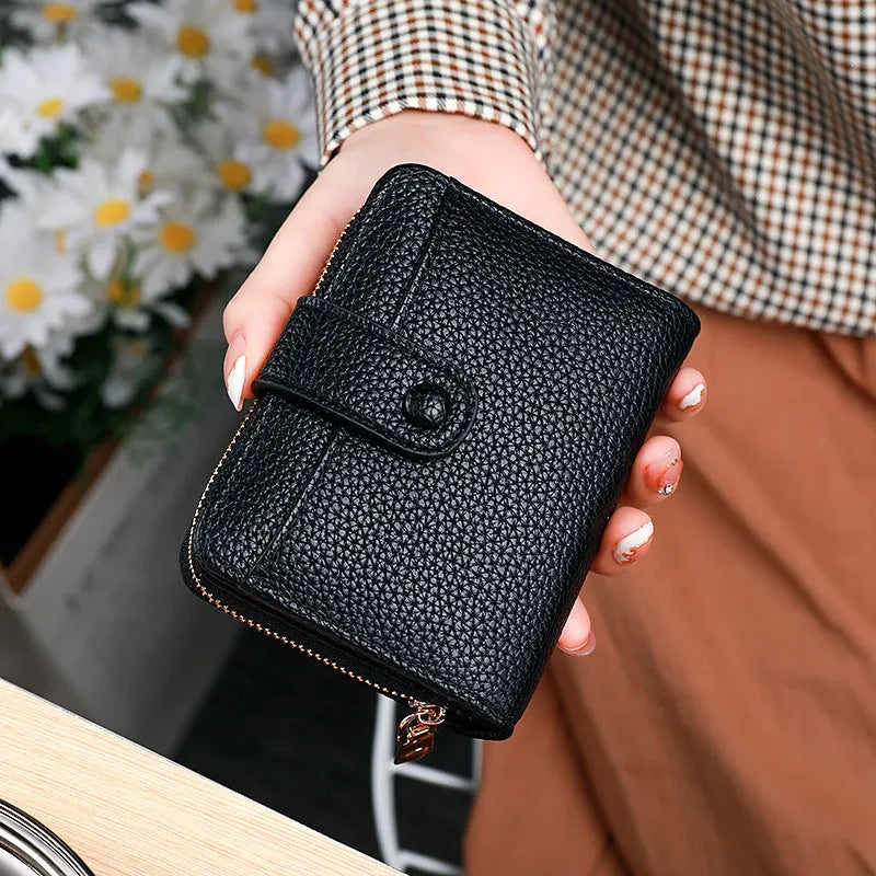 Women's lychee pattern PU short wallet in beige, pink, black, or red with antibacterial lining.