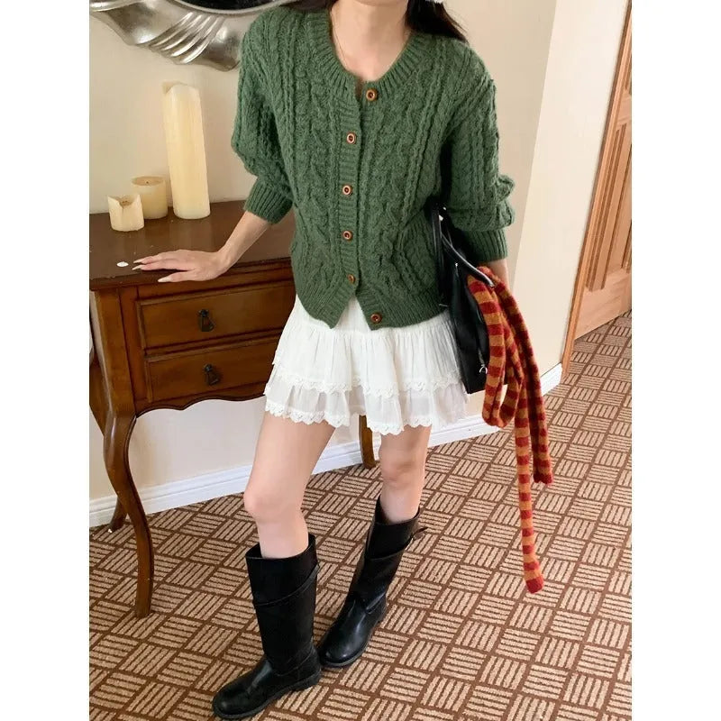 Solid colour thick needle twisted texture knitted cardigan in beige, short length, on model