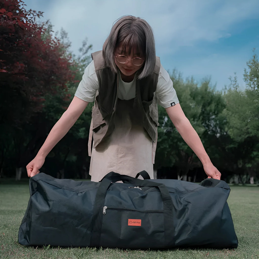 Green heavy-duty waterproof storage bag for folding camping chairs and tables, shown folded and expanded.