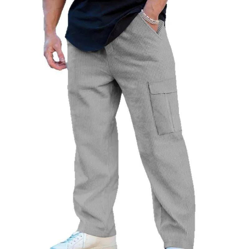 Men's straight-leg corduroy trousers in navy blue, showing loose fit and drawstring waist detail.