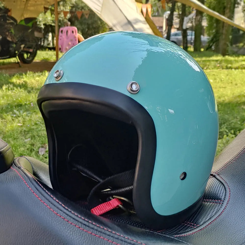Retro-style motorcycle half helmet in cement grey with a glossy fibreglass shell on a plain background.