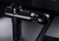 Black fascia gun with silicone head and ABS body for muscle recovery USB powered