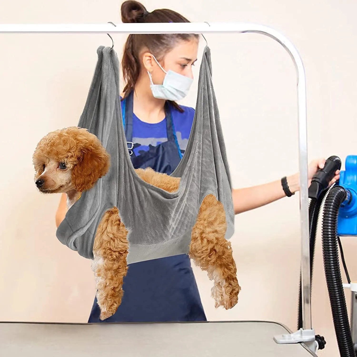 Pet grooming hammock in blue double-layer flannel fabric with reinforced grommets on a white background, available in three sizes