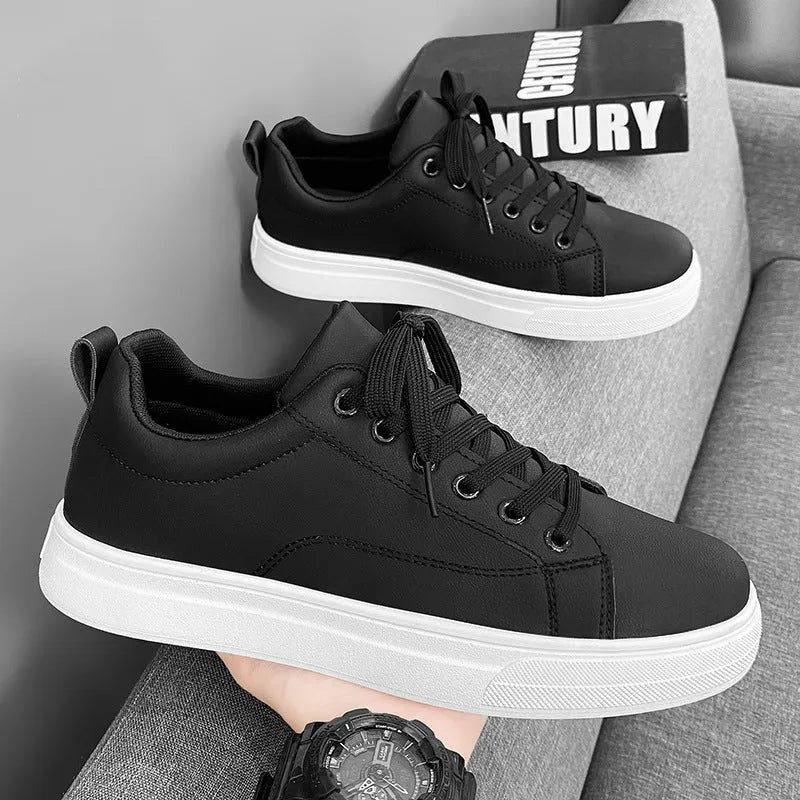 Men's low-top Korean-style casual sneakers in black on white colour with round toe and flat rubber sole.
