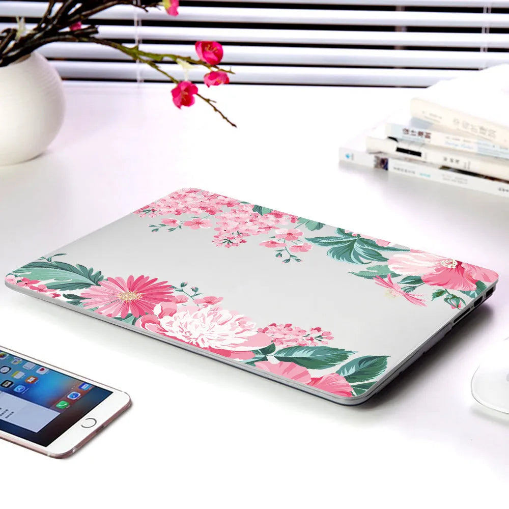 MacBook protective shell with floral pattern design covering laptop top and bottom surfaces