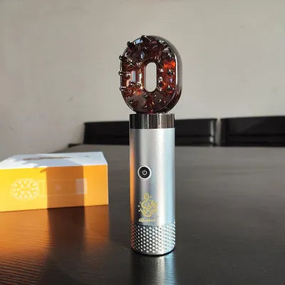 USB rechargeable Middle Eastern comb aromatherapy stove in silver, 14x5x4cm, on a car dashboard