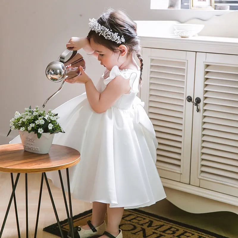 Girls' white satin princess dress with puff sleeves, full-length view, white fabric