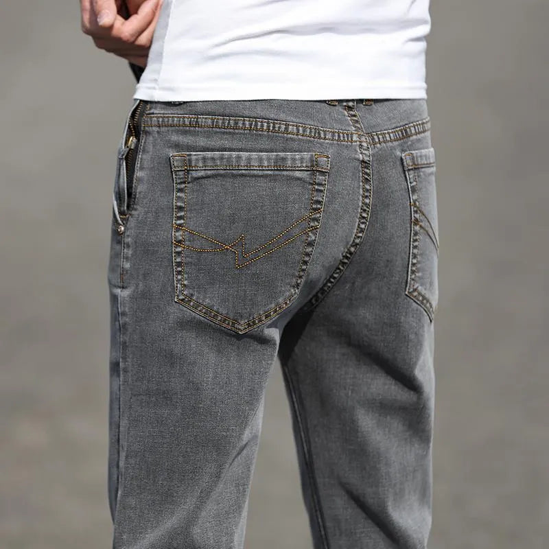 Men's smoky gray straight leg jeans with low waist and zipper fly, made from rabbit fur fabric.