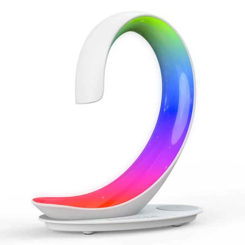 White swan-shaped desktop device functioning as a wireless charger, Bluetooth speaker, and colourful LED atmosphere lamp.