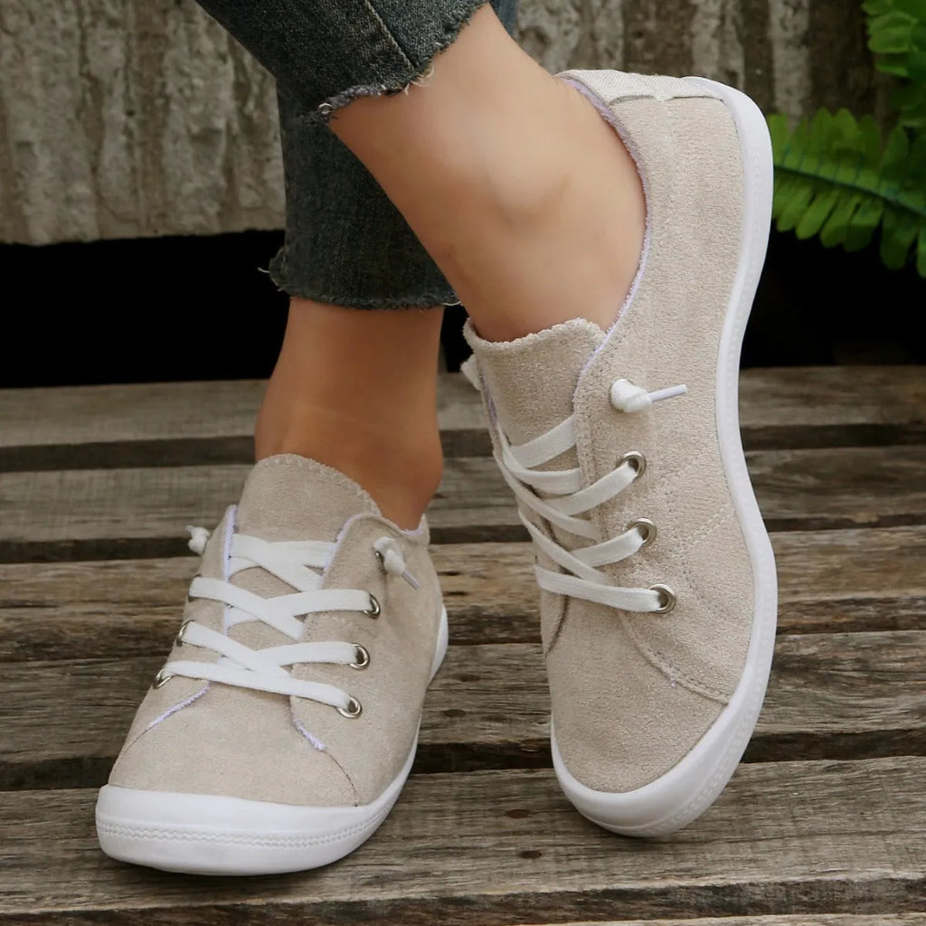 Women's beige low-top fabric casual sneakers with a rubber sole on a neutral background.