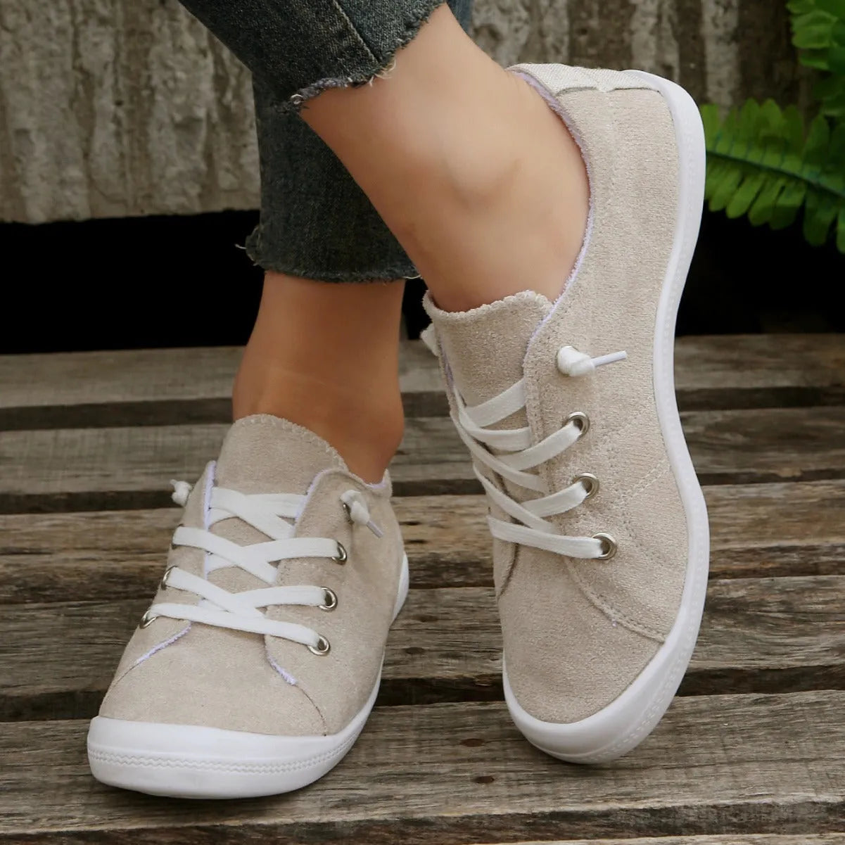 Women's beige low-top fabric casual sneakers with a rubber sole on a neutral background.