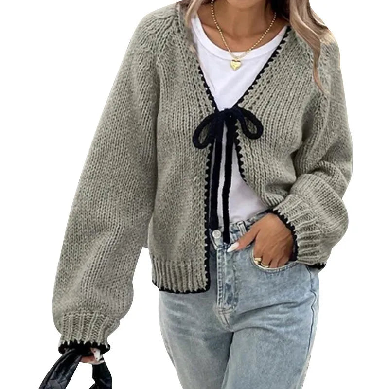Lace-up cardigan sweater with crocheted flower detailing in solid colour