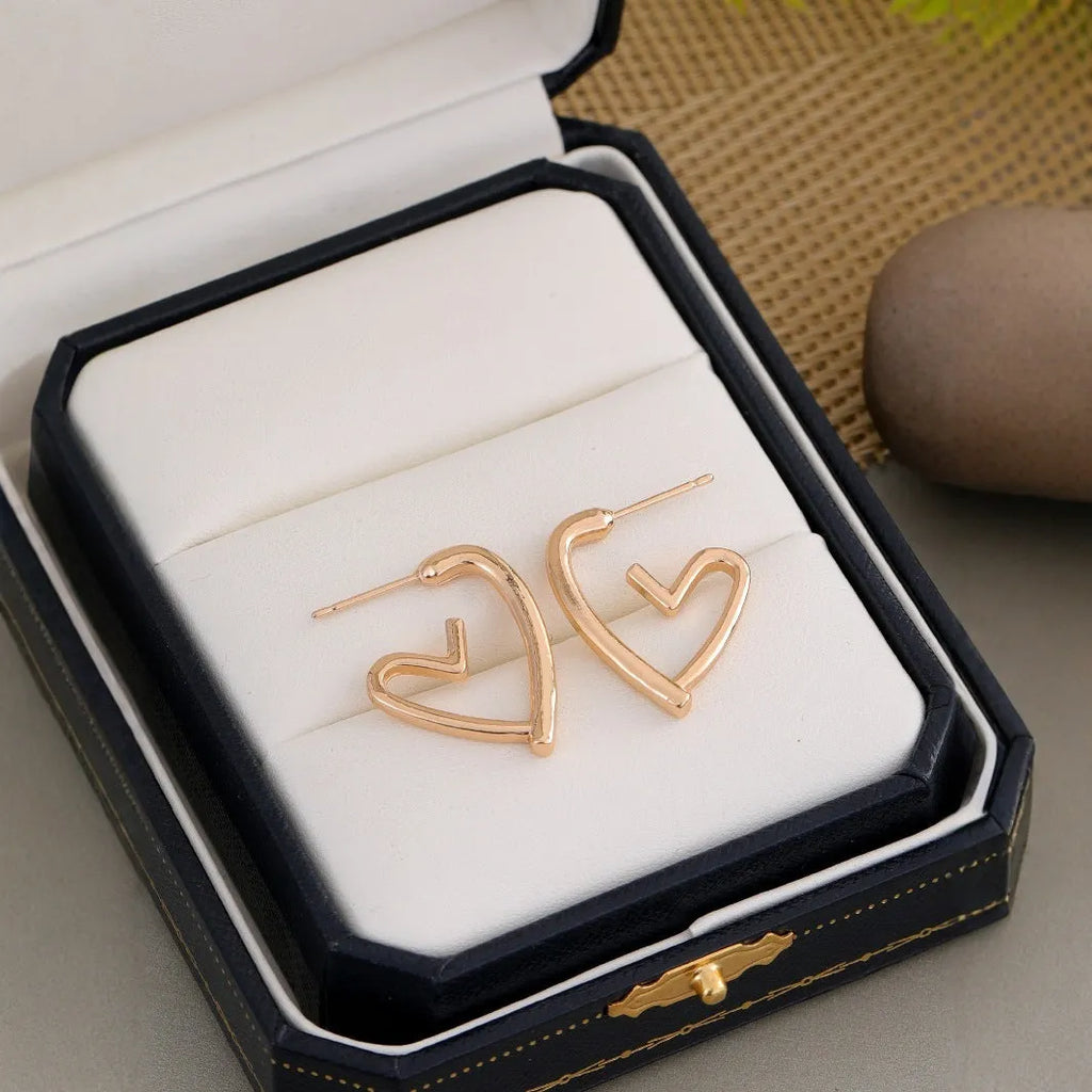 Simple cold style love earrings for women in golden colour metal alloy finish