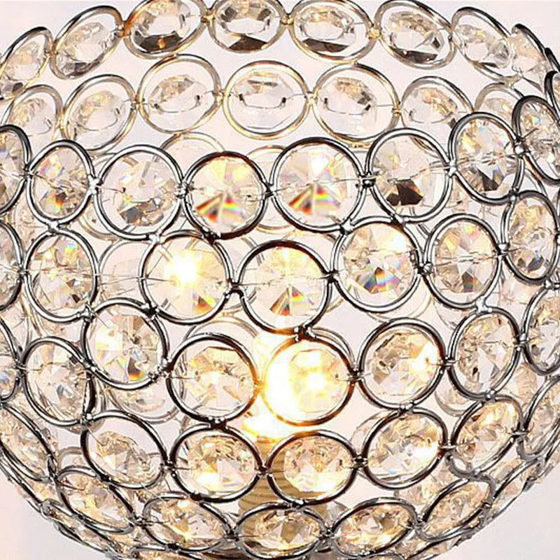 Modern minimalist crystal USB table lamp with heart-shaped design on a bedside table