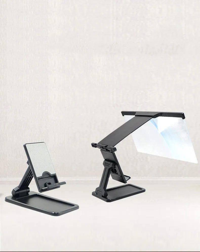 Black foldable mobile phone screen magnifier with detachable phone holder shown on a desktop.